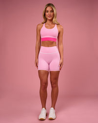 Woman wearing Pinnacle High-Rise 6" Short - Pink Rose-White | Model:Issy | Size:XS | Thumbnail Index: 2
