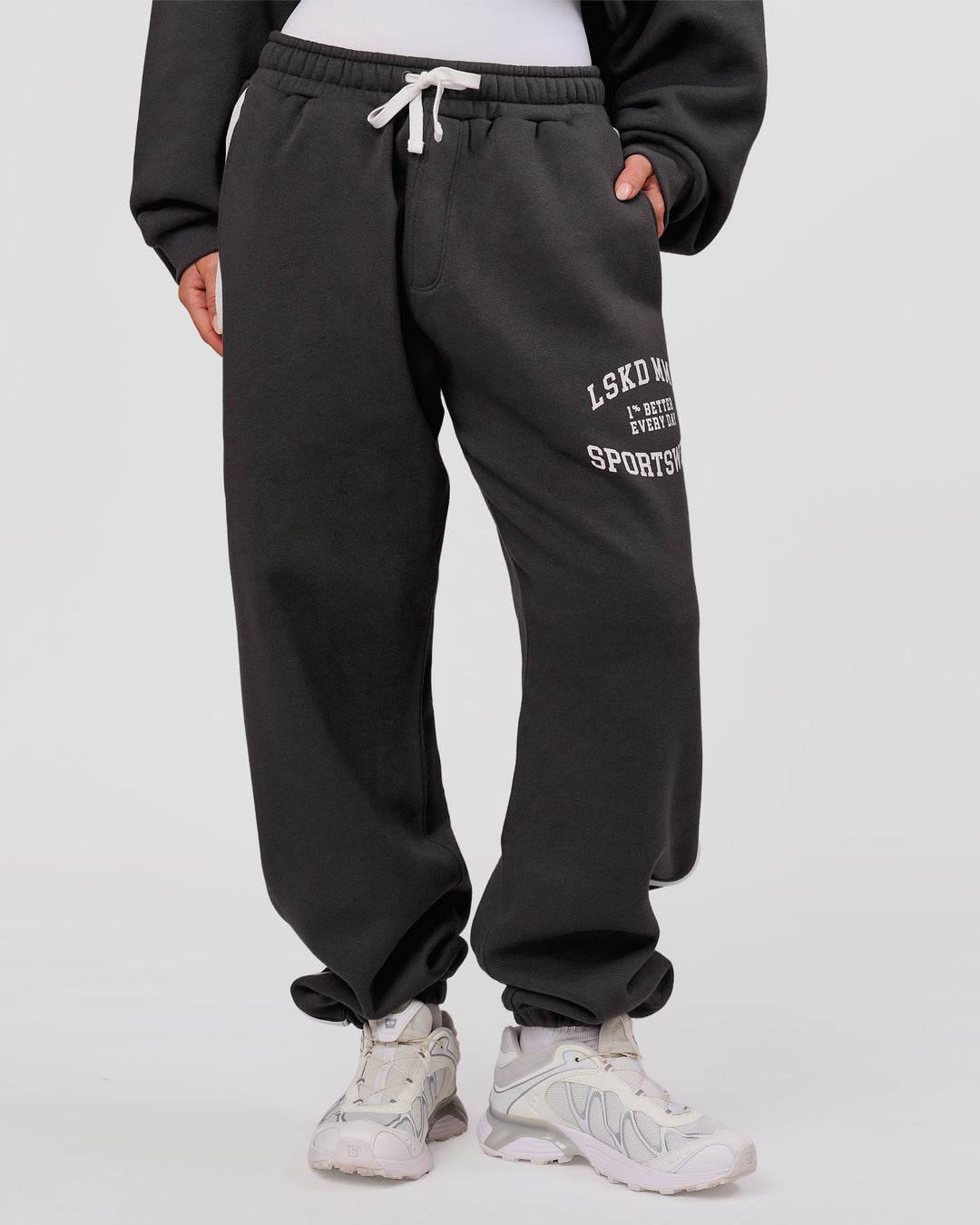 Woman wearing Playbook Baggy Cuffed Track Pant - Onyx-Off White | Model:Issy | Size:XS - view 8