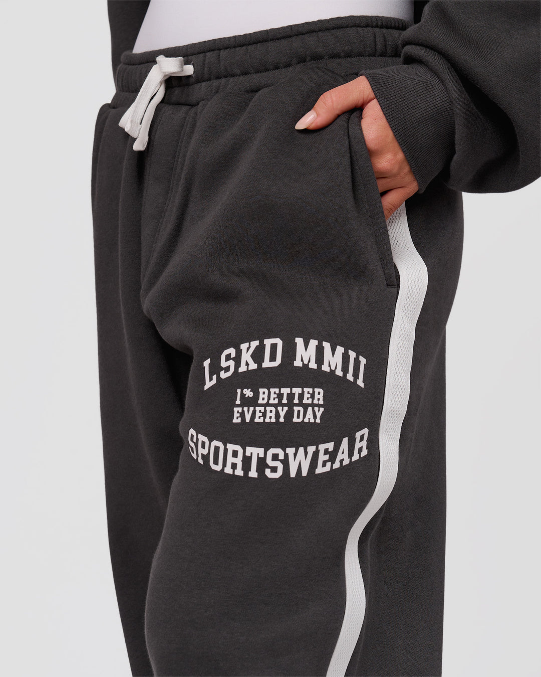 Woman wearing Playbook Baggy Cuffed Track Pant - Onyx-Off White | Model:Issy | Size:XS - view 9