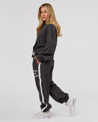 Woman wearing Playbook Baggy Cuffed Track Pant - Onyx-Off White | Model:Issy | Size:XS | Thumbnail Index: 14