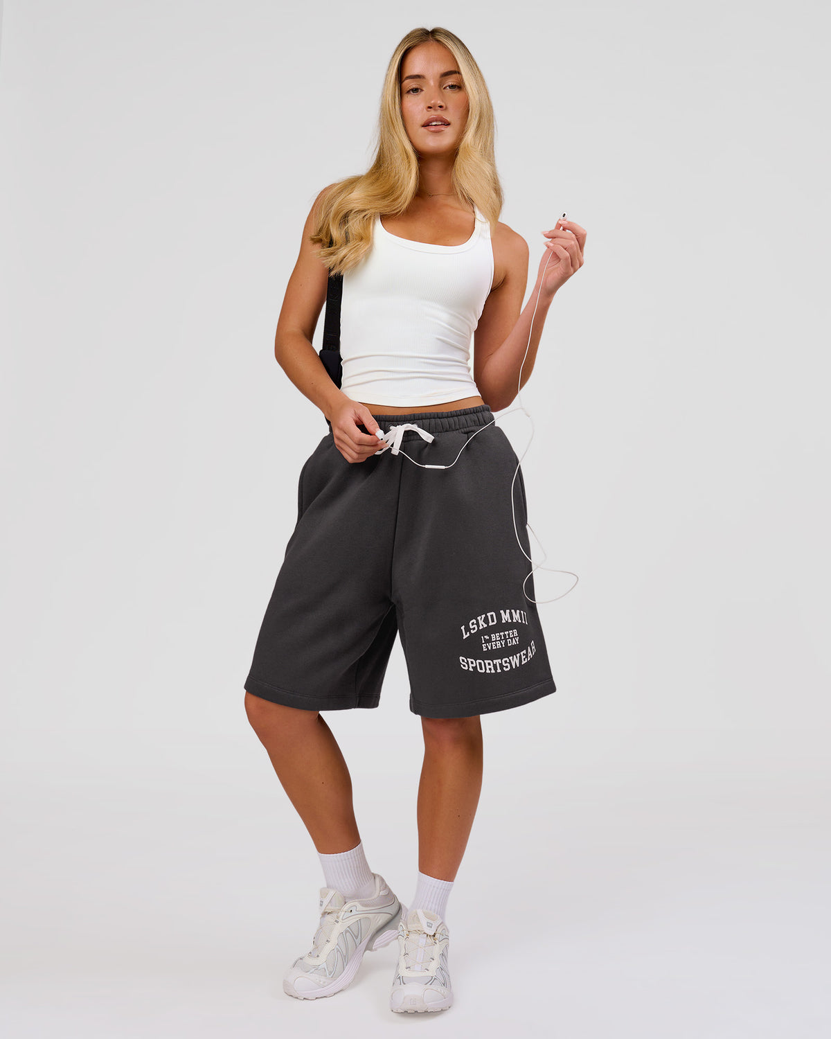 Woman wearing Playbook Varsity Fleece Shorts - Onyx-Off White | Model:Issy | Size:XS - view 1