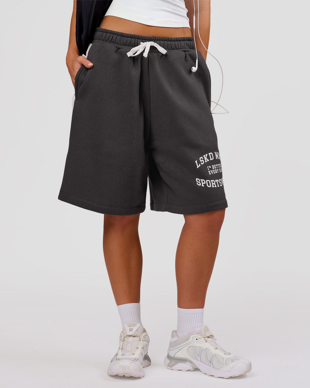 Woman wearing Playbook Varsity Fleece Shorts - Onyx-Off White | Model:Issy | Size:XS - view 2