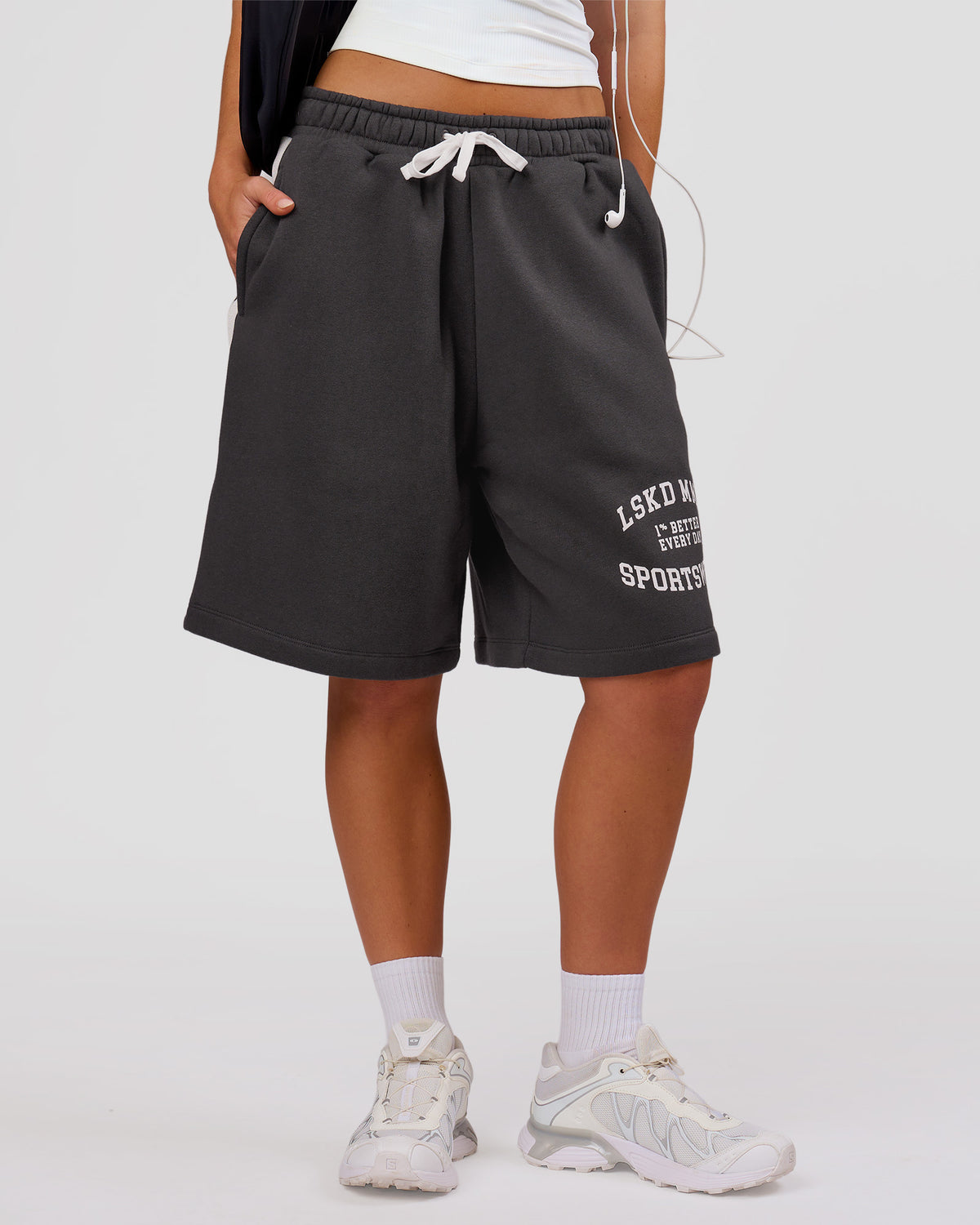 Woman wearing Playbook Varsity Fleece Shorts - Onyx-Off White | Model:Issy | Size:XS - view 2