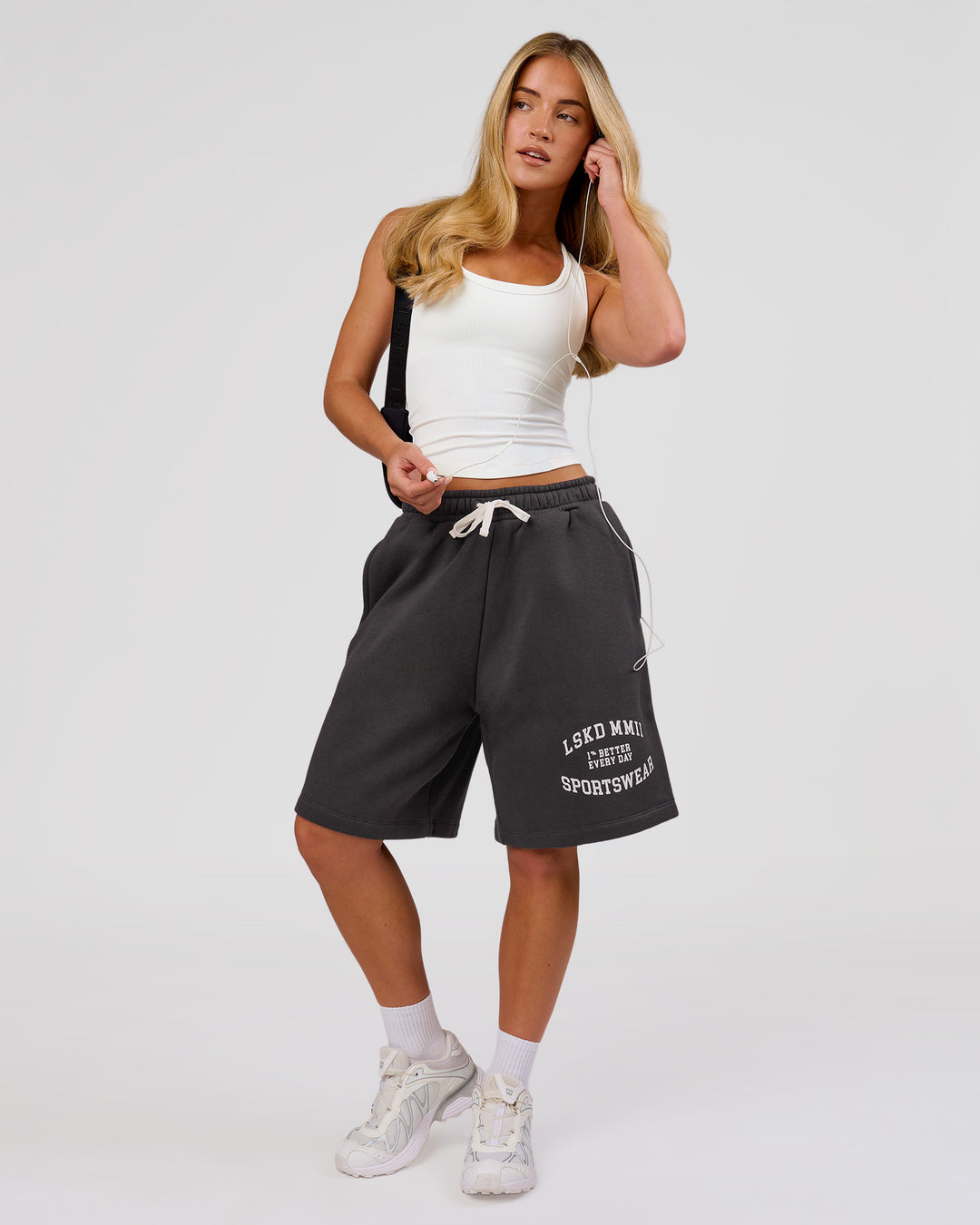Woman wearing Playbook Varsity Fleece Shorts - Onyx-Off White | Model:Issy | Size:XS - view 12