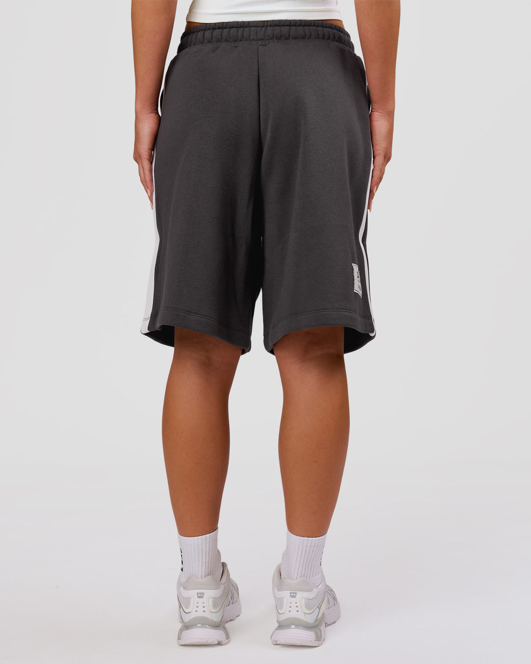 Woman wearing Playbook Varsity Fleece Shorts - Onyx-Off White | Model:Issy | Size:XS - view 16