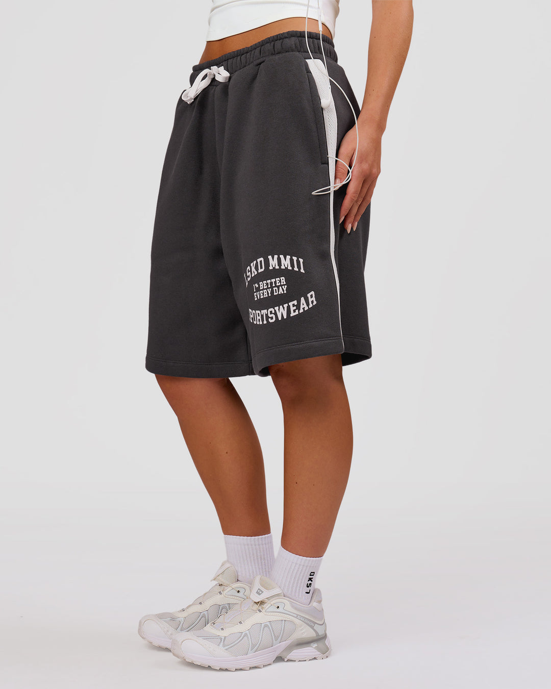 Woman wearing Playbook Varsity Fleece Shorts - Onyx-Off White | Model:Issy | Size:XS - view 18