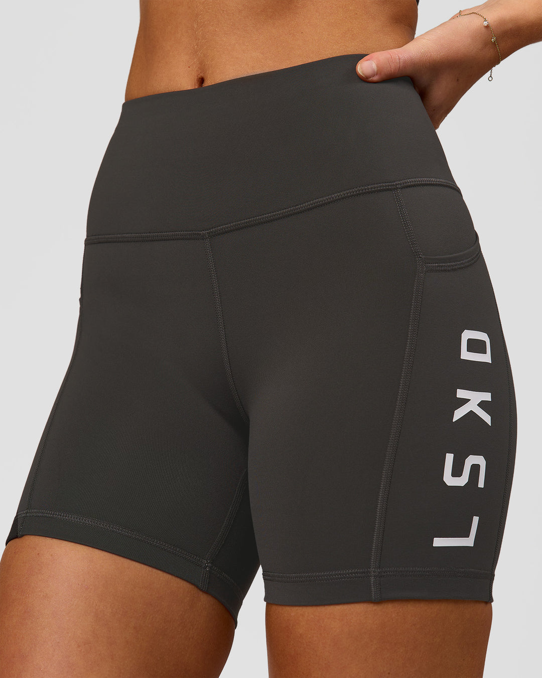 Woman wearing Rep Ultra High-Rise 4" Short Pockets - Onyx-White | Model:Issy | Size:XS - view 1