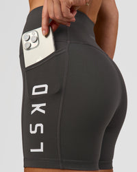 Woman wearing Rep Ultra High-Rise 4" Short Pockets - Onyx-White | Model:Issy | Size:XS | Thumbnail Index: 1