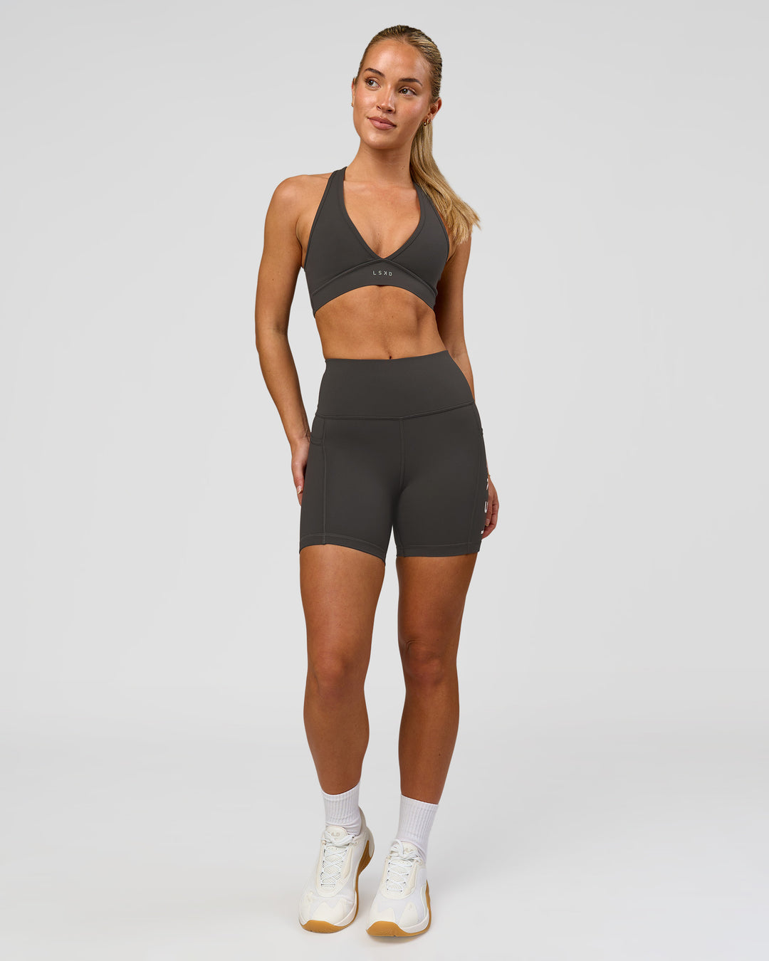 Woman wearing Rep Ultra High-Rise 4" Short Pockets - Onyx-White | Model:Issy | Size:XS - view 4