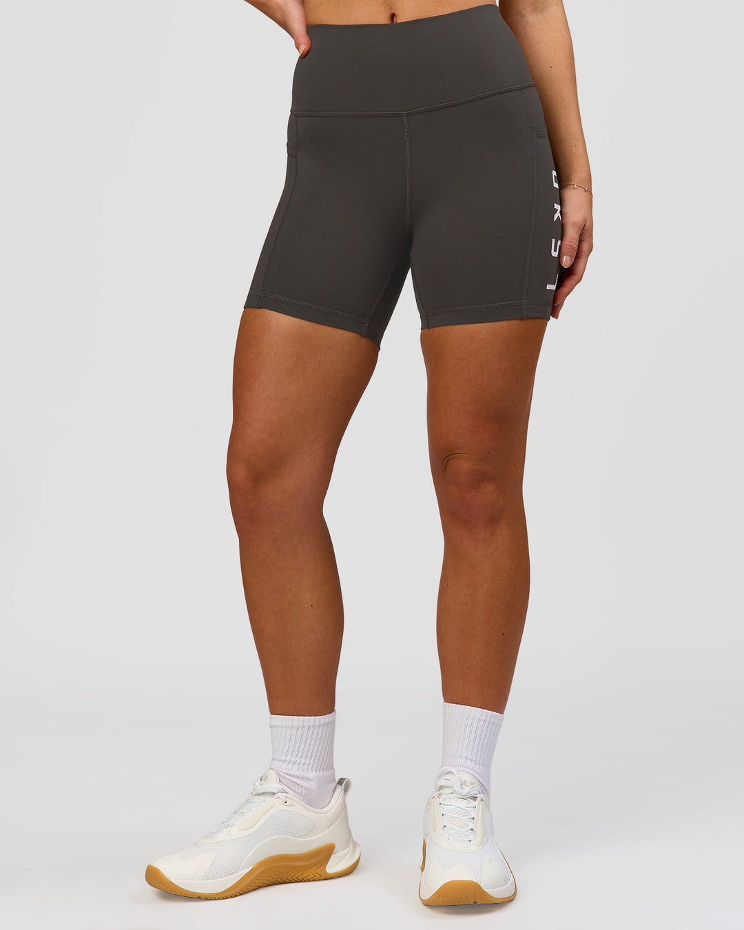 Woman wearing Rep Ultra High-Rise 4" Short Pockets - Onyx-White | Model:Issy | Size:XS - view 6
