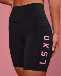 Woman wearing Rep Ultra High-Rise 6" Short Pockets - Black-Pink Rose | Model:Issy | Size:XS | Thumbnail Index: 3