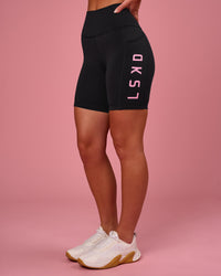 Woman wearing Rep Ultra High-Rise 6" Short Pockets - Black-Pink Rose | Model:Issy | Size:XS | Thumbnail Index: 7