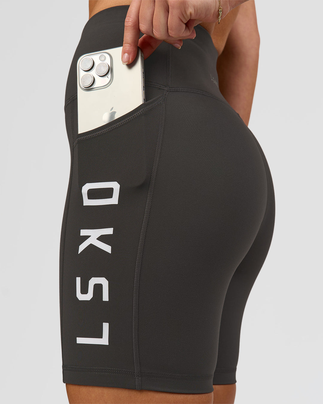 Woman wearing Rep Ultra High-Rise 6" Short Pockets - Onyx-white | Model:Issy | Size:XS - view 1