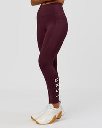 Woman wearing Rep Ultra High-Rise 7/8 Legging Pockets - Cherry Lacquer-White | Model:Issy | Size:XS | Thumbnail Index: 3