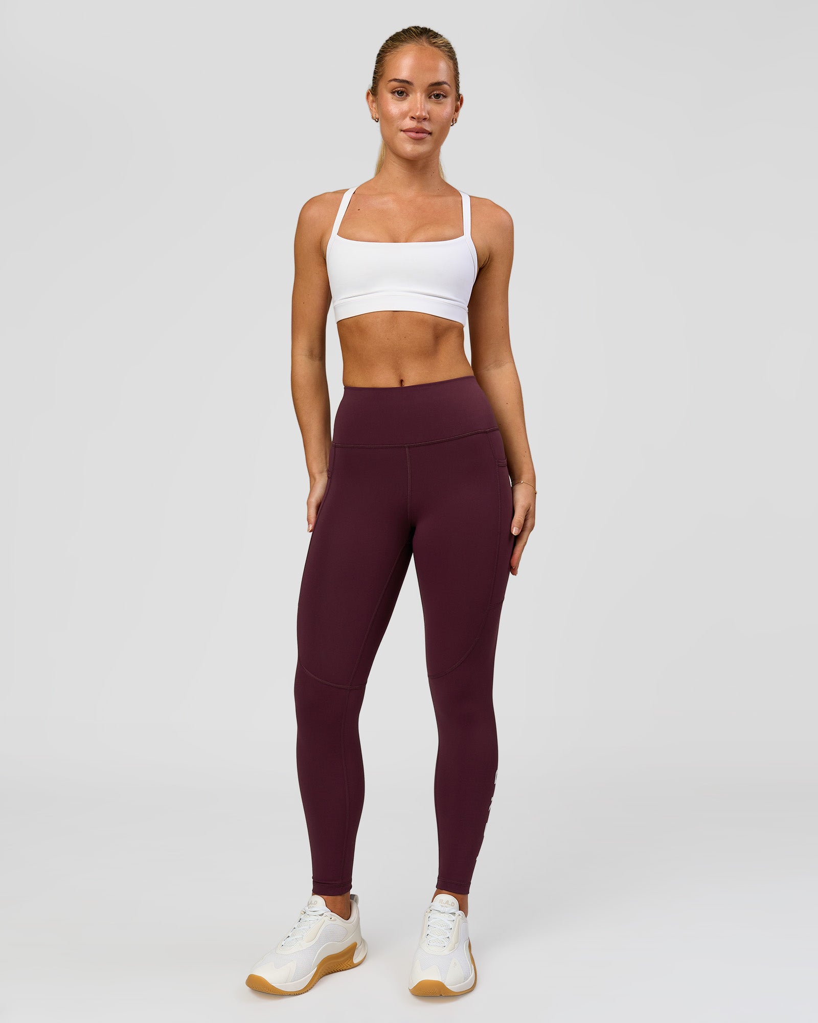 Woman wearing Rep Ultra High-Rise 7/8 Legging Pockets - Cherry Lacquer-White | Model:Issy | Size:XS