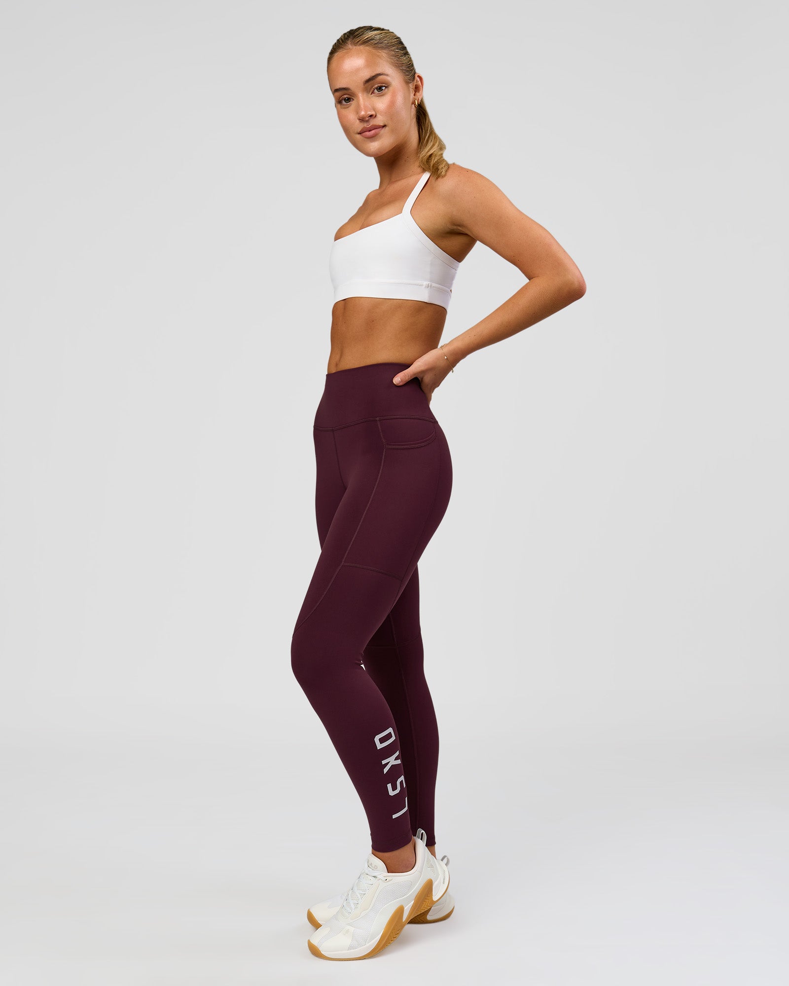 Woman wearing Rep Ultra High-Rise 7/8 Legging Pockets - Cherry Lacquer-White | Model:Issy | Size:XS