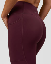 Woman wearing Rep Ultra High-Rise 7/8 Legging Pockets - Cherry Lacquer-White | Model:Issy | Size:XS | Thumbnail Index: 6