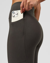 Woman wearing Rep Ultra High-Rise 7/8 Legging Pockets - Onyx-white | Model:Issy | Size:XS | Thumbnail Index: 1
