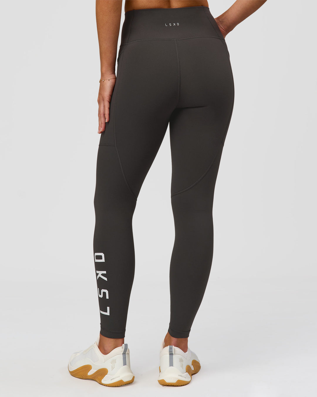 Woman wearing Rep Ultra High-Rise 7/8 Legging Pockets - Onyx-white | Model:Issy | Size:XS - view 5