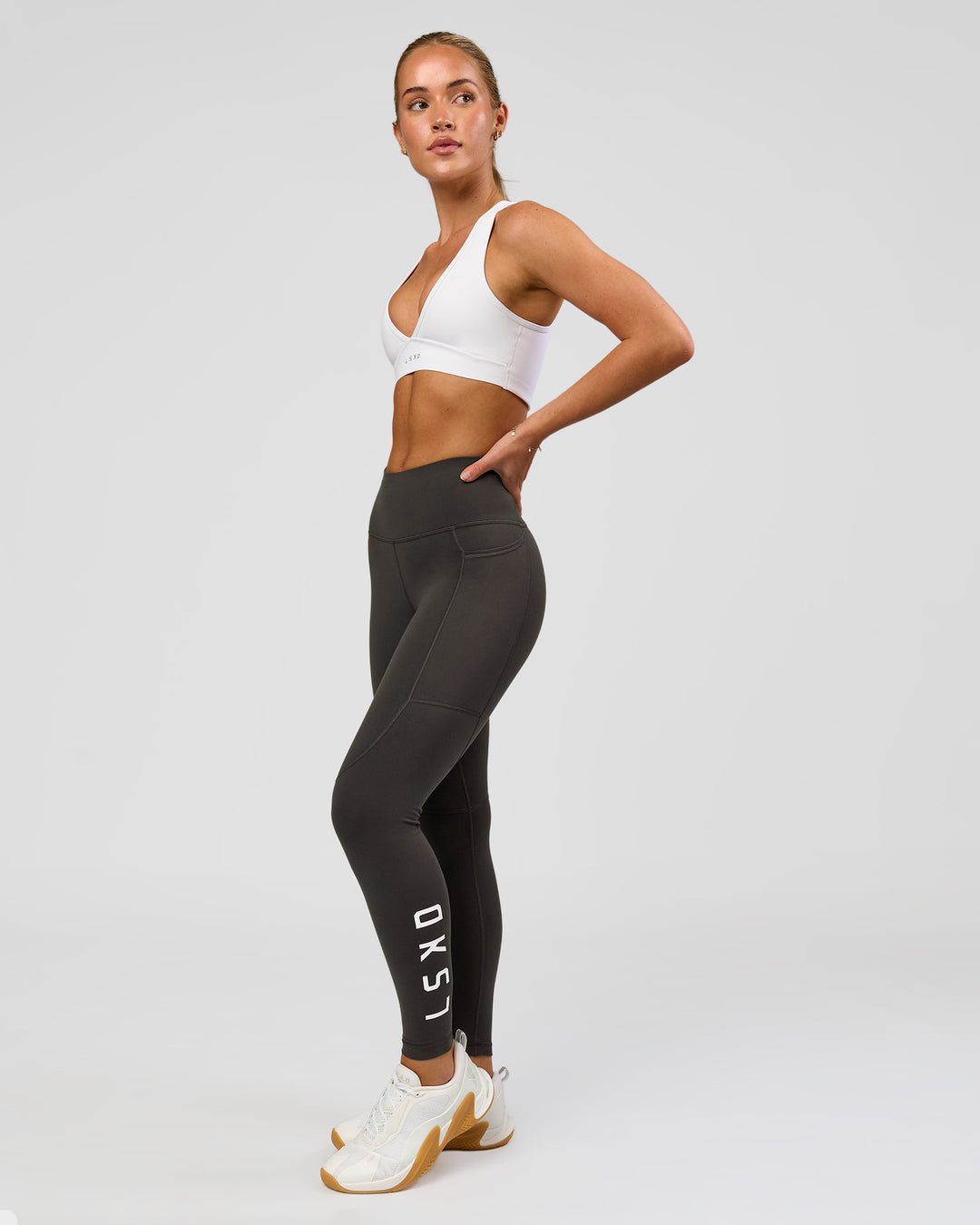 Woman wearing Rep Ultra High-Rise 7/8 Legging Pockets - Onyx-white | Model:Issy | Size:XS - view 6