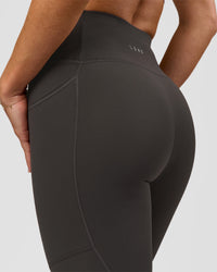 Woman wearing Rep Ultra High-Rise 7/8 Legging Pockets - Onyx-white | Model:Issy | Size:XS | Thumbnail Index: 6