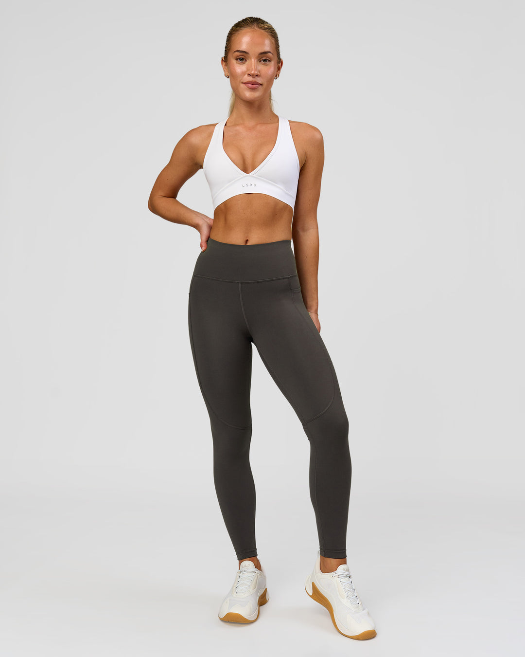 Woman wearing Rep Ultra High-Rise 7/8 Legging Pockets - Onyx-white | Model:Issy | Size:XS - view 8