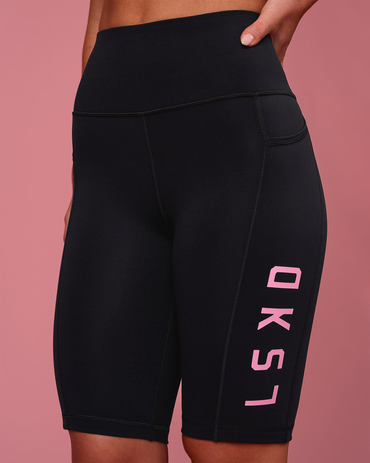Woman wearing Rep Ultra High-Rise 9" Short Pockets - Black-Pink Rose | Model:Issy | Size:XS