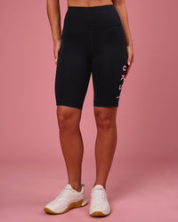 Woman wearing Rep Ultra High-Rise 9" Short Pockets - Black-Pink Rose | Model:Issy | Size:XS | Thumbnail Index: 4