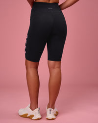 Woman wearing Rep Ultra High-Rise 9" Short Pockets - Black-Pink Rose | Model:Issy | Size:XS | Thumbnail Index: 7