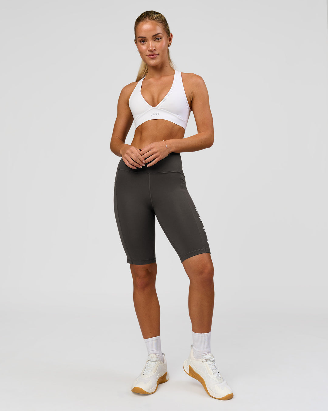Woman wearing Rep Ultra High-Rise 9" Short Pockets - Onyx-white | Model:Issy | Size:XS - view 6