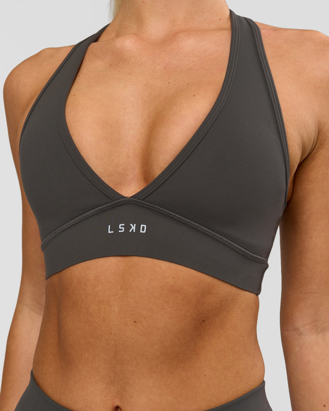 Woman wearing Stamina Sports Bra - Onyx | Model:Issy | Size:XS - view 1