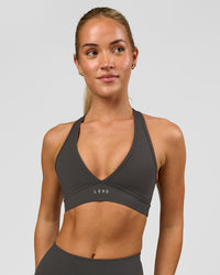 Woman wearing Stamina Sports Bra - Onyx | Model:Issy | Size:XS | Thumbnail Index: 2