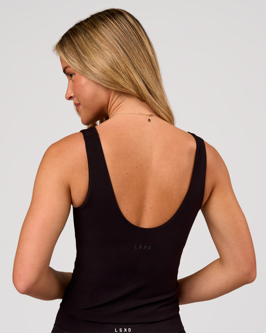 Woman wearing Staple 2.0 Active Shelf Bra Tank - Black | Model:Issy | Size:XS - view 2