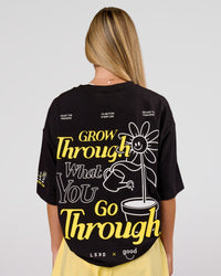 Woman wearing TGHF X LSKD 26 FLXCotton Oversized Tee - Black | Model:Issy | Size:XS | Thumbnail Index: 1
