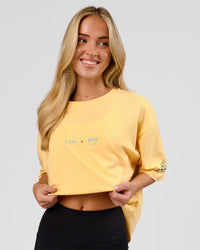 Woman wearing TGHF X LSKD 26 FLXCotton Oversized Tee - Lemon | Model:Issy | Size:XS | Thumbnail Index: 5