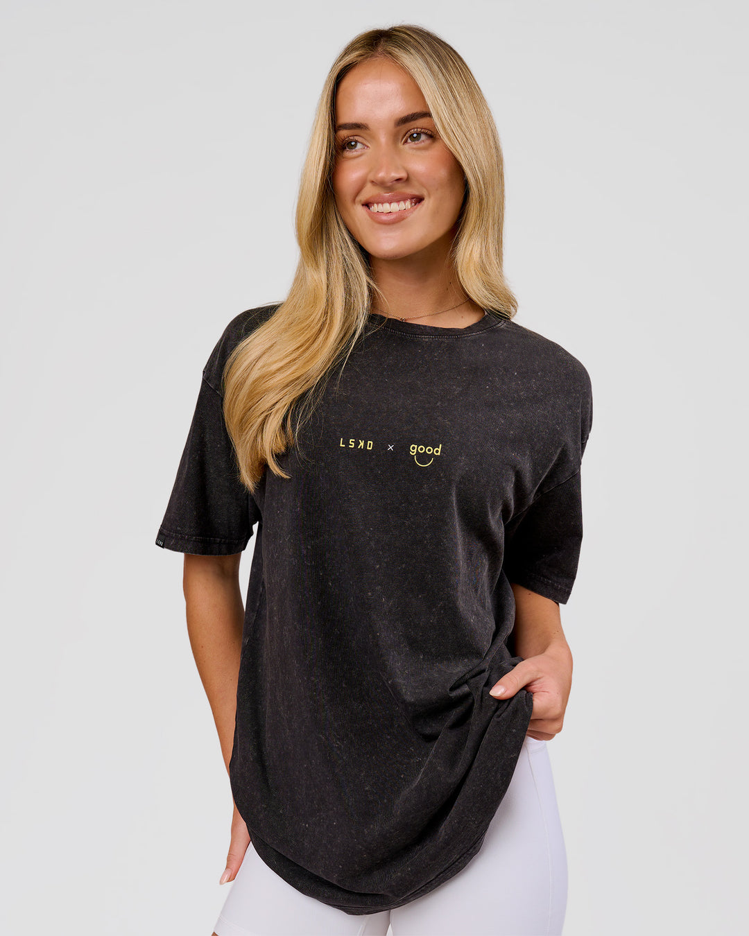 Woman wearing TGHF X LSKD 26 FLXCotton Oversized Tee - Black Washed | Model:Issy | Size:XS - view 9