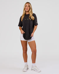 Woman wearing TGHF X LSKD 26 FLXCotton Oversized Tee - Black Washed | Model:Issy | Size:XS | Thumbnail Index: 12