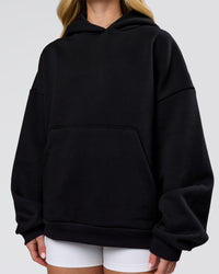 Woman wearing Tonal Legacy Boxy Hoodie - Black-Black | Model:Issy | Size:XS | Thumbnail Index: 5