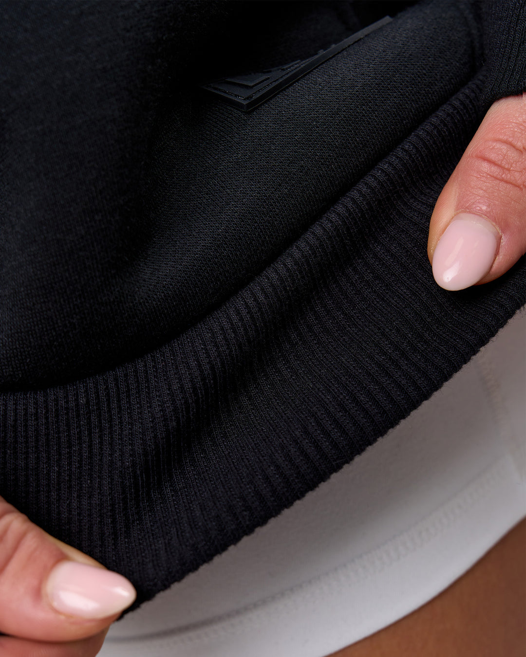 Woman wearing Tonal Legacy Boxy Hoodie - Black-Black | Model:Issy | Size:XS - view 19