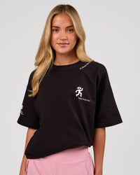 Woman wearing Values Manifesto Heavyweight Oversized Tee  - Black-White | Model:Issy | Size:XS | Thumbnail Index: 2