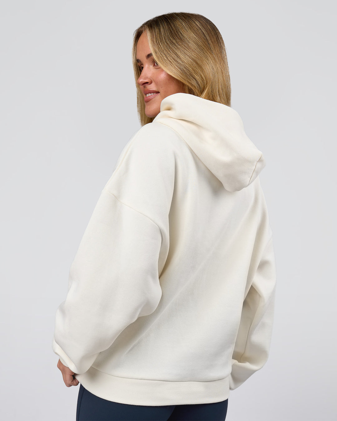 Woman wearing Varsity Boxy Hoodie - Off White-Pink Rose | Model:Issy | Size:XS - view 13