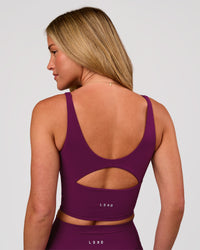Woman wearing Vitality Long Line Sports Bra - Plum Caspia | Model:Issy | Size:XS | Thumbnail Index: 3