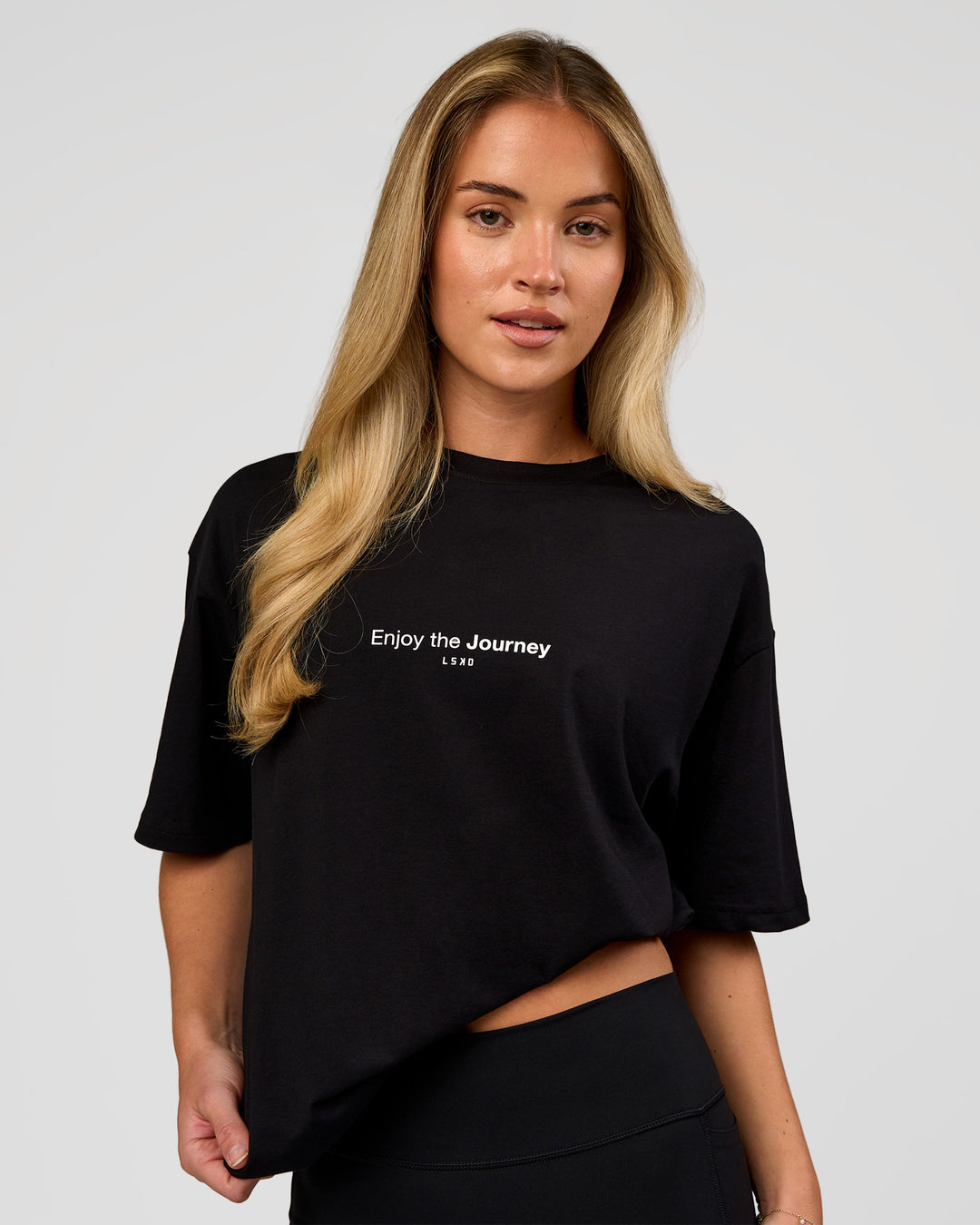 Woman wearing VS1 Enjoy The Journey FLXCotton Oversize Tee - Black | Model:Issy | Size:XS - view 3