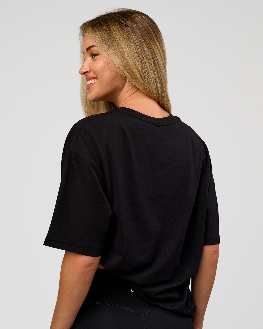 Woman wearing VS1 Enjoy The Journey FLXCotton Oversize Tee - Black | Model:Issy | Size:XS - view 5