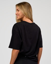 Woman wearing VS1 Enjoy The Journey FLXCotton Oversize Tee - Black | Model:Issy | Size:XS | Thumbnail Index: 4