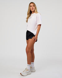 Woman wearing VS1 Enjoy The Journey FLXCotton Oversize Tee - White | Model:Issy | Size:XS | Thumbnail Index: 11