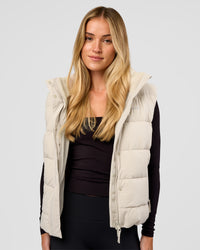 Woman wearing Go-To Puffer Vest - Shale Beige | Model:Izzy | Size:XS