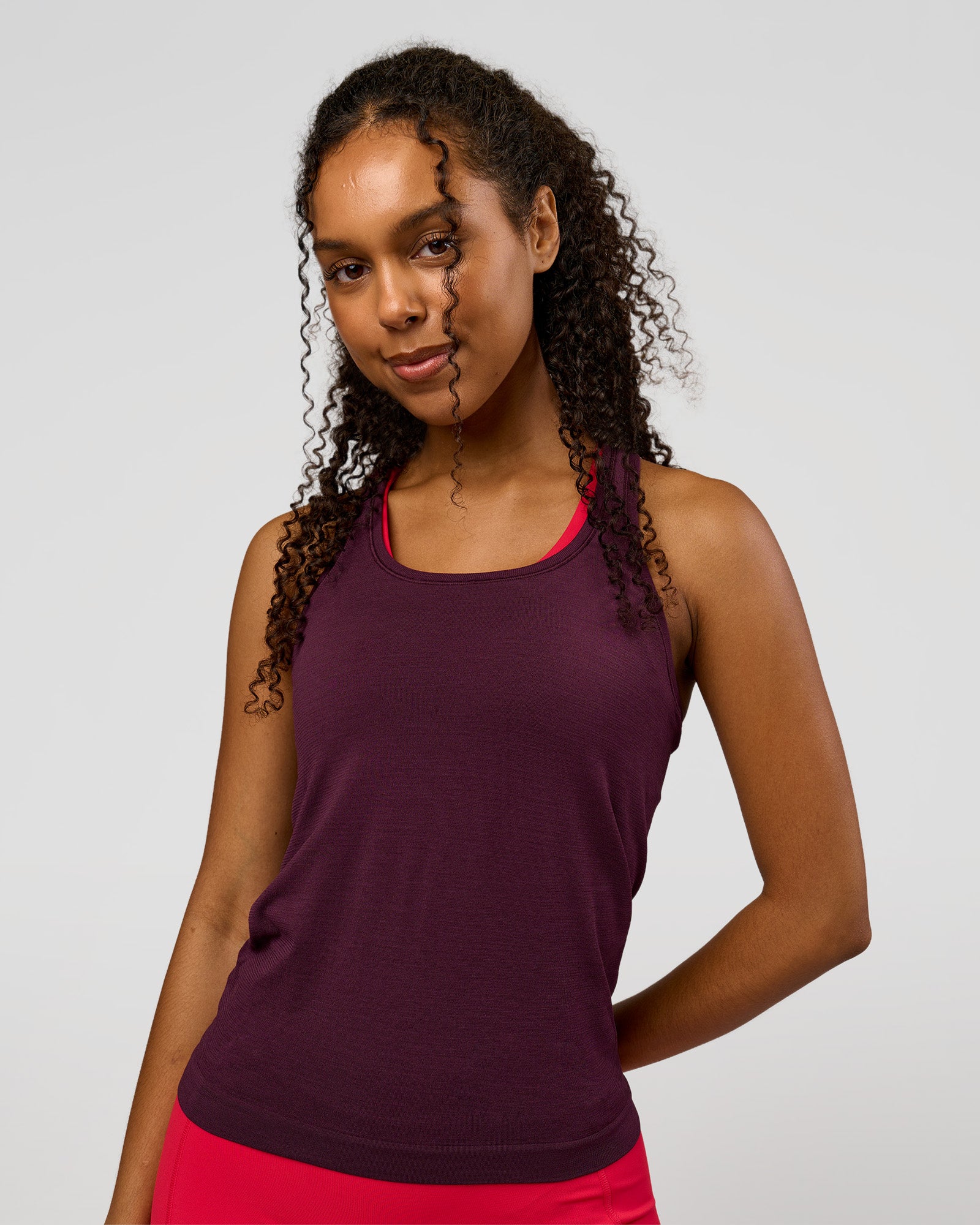 Woman wearing AeroFLX+ Seamless Tank - Cherry Lacquer/Cherry Lacquer | Model:Jordan | Size:XS