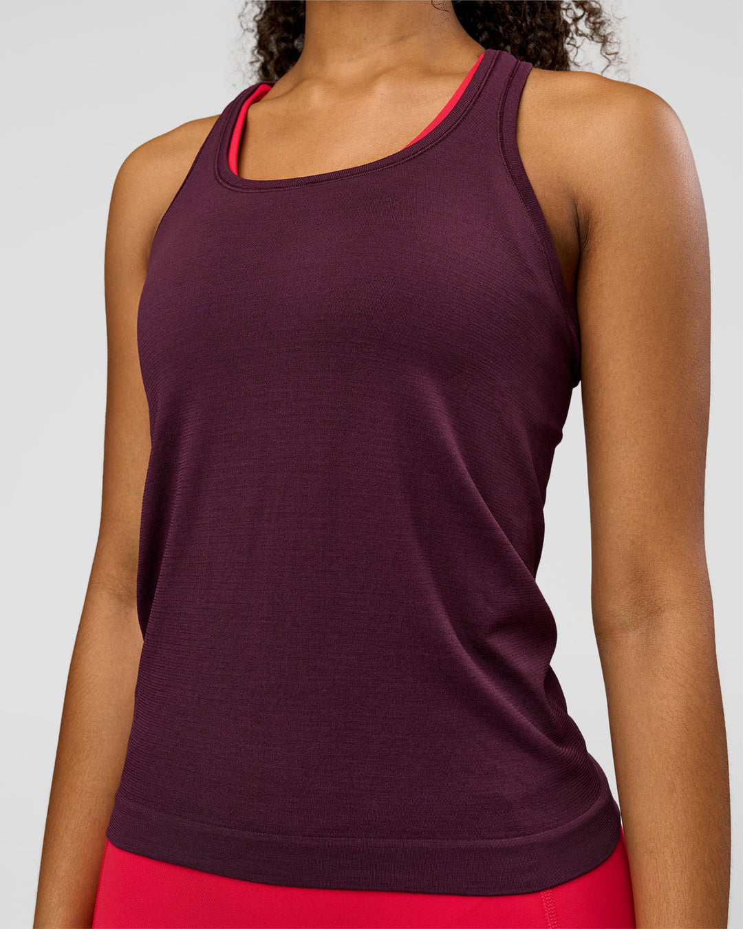Woman wearing AeroFLX+ Seamless Tank - Cherry Lacquer/Cherry Lacquer | Model:Jordan | Size:XS - view 3