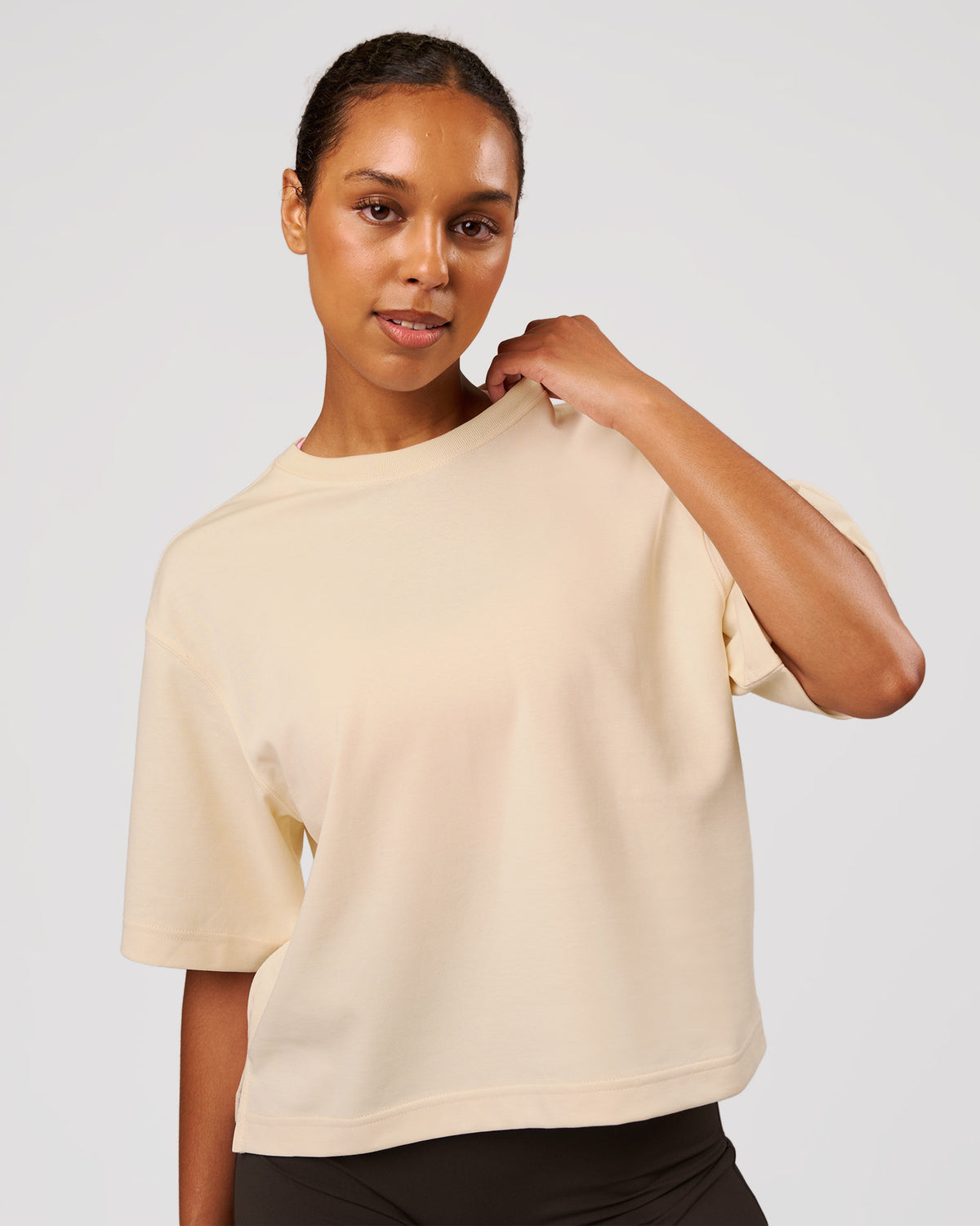 Woman wearing AfterDark ZeroCrease Cropped Tee - Vanilla Bean | Model:Jordan | Size:XS